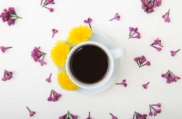 Still life with a cup of coffee and flowers on a wooden table....
