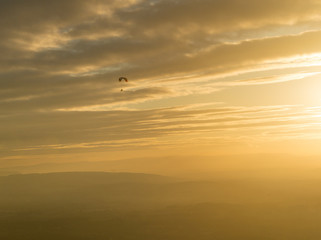 Motor trike hang glider flying in the sunset Malvern hills Worcestershire