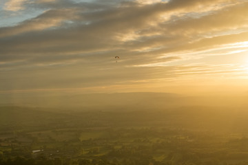 Motor trike hang glider flying in the sunset Malvern hills Worcestershire