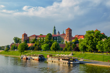 Naklejka na ściany i meble Wawel castle famous landmark in Krakow Poland. River Wisla view. Summer or spring green landscape