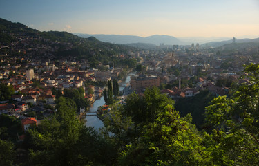 Fototapeta na wymiar Overlooking city center of Sarajevo from a nearby hill during sunset. 