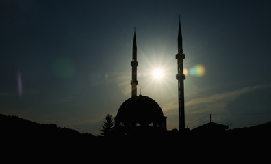 Kalibunarska džamija (mosque) located in Travnik, Bosnia and Herzegovina. Sunset time when the sun is located right between two minarets of the mosque.