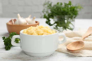 Bowl with mashed potatoes on wooden table