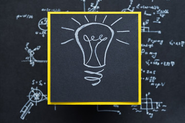 lamp. eureka genius illumination breakthrough concept. drawing on black paper with yellow contrast...