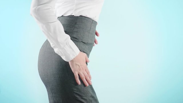 Beautiful business woman on a colored background. close-up skirt. dress code, move the hips. 4k, slow motion