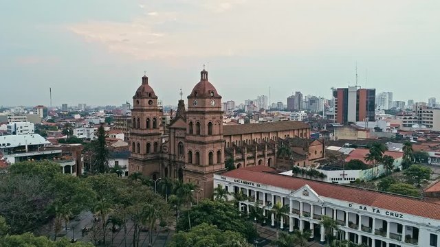 areal footage of the city with a cathedral and the main square in sight