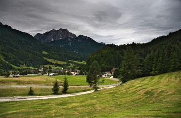 Fototapeta na wymiar Overlooking village of Podkoren with the Kamnik–Savinja Alps at the back.