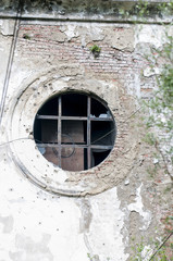 large round window in an old abandoned building.