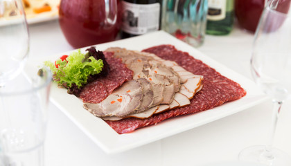 Served table layout with meat sliced snack plate