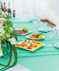 Blue wedding table with snacks and flowers