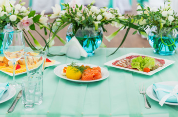 Blue wedding table with snacks and flowers