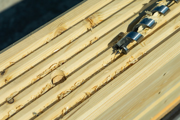 Drilling holes in laminated veneer lumber for shkantov. Construction of the house from the profiled glued bar.