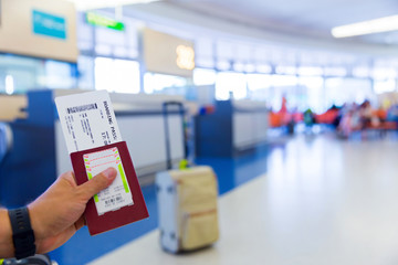 Passport with boarding pass at departure terminal gate in airport