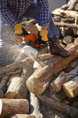 The worker works with a chainsaw. Chainsaw close-up.