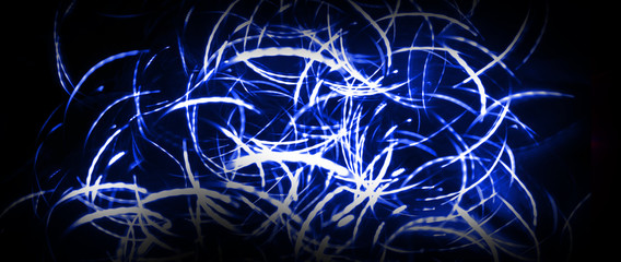 Neon sparks on a dark background. Neon light, laser. Blurred background. Abstract dark festive background.
