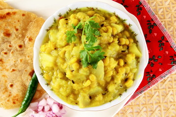 traditional indian gujarati  food dudhi chana curry shak stew recipe with roti or bhakhri or chapati