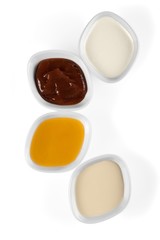 the various barbecue sauces in ceramic bowls