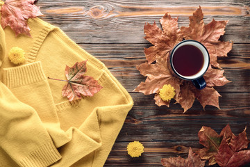 Autumn fashion seasonal concept sweater cardigan cup hot black tea