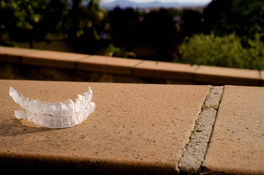 Transparent dental orthodontics on brown floor
