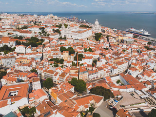 Fototapeta na wymiar Beautiful super wide-angle aerial view of Lisbon, Portugal with harbor and skyline scenery beyond the city, shot from drone