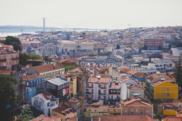 Fototapeta na wymiar Beautiful super wide-angle aerial view of Lisbon, Portugal with harbor and skyline scenery beyond the city, shot from belvedere observation deck
