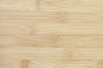Board made of natural bamboo wood. Textures pattern background in light yellow cream beige brown color.