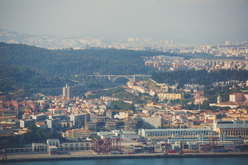 Fototapeta premium Beautiful super wide-angle panoramic aerial view of Lisbon, Portugal with harbor and skyline scenery beyond the city, shot from belvedere observation deck of Cristo Rei