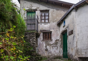 Fototapeta na wymiar Old abandoned and crumbling rural house