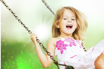 Little child blond girl having fun on