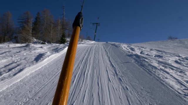 FPV of skier going up on anchor ski lift