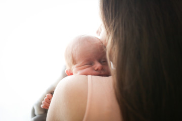 sweet newborn baby sleep on gentle hands of mom