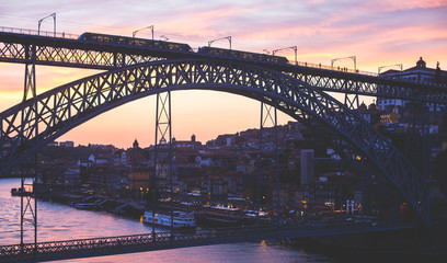 Beautiful super wide-angle summer aerial view of Porto, Portugal, with Douro river and famous view of Dom Luis I Bridge in Porto skyline and scenery beyond the old town, during the sunset