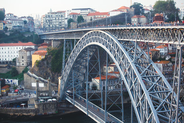 Fototapeta premium Beautiful super wide-angle summer aerial view of Porto, Portugal, with Douro river and famous view of Dom Luis I Bridge in Porto skyline and scenery beyond the old town, during the sunset