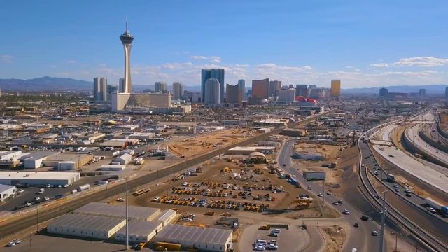 Aerial view of Las Vegas strip in Nevada, USA. View of the Stratosphere hotel and other popular buildings as well as highway and roads through the city.