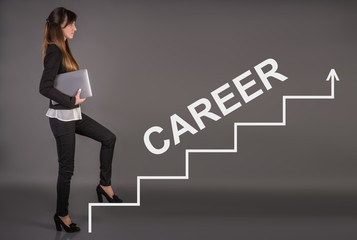 Creative concept about success. Career ladder. Business woman with a laptop on a gray background. Office worker