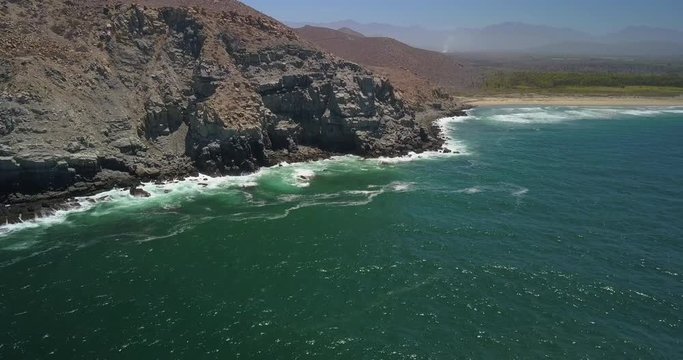 Aerial Forward Descending: Waves Splashing on Shore