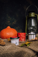  Halloween background. Molten candles. Carrying out the ritual.  Halloween in rustic style. Autumn mood. All hallows' day. Pumpkin, lamp, candles. Harvest. Countryside.