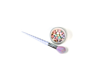 isolated makeup tools brushes with powder balls white back unicorn colour