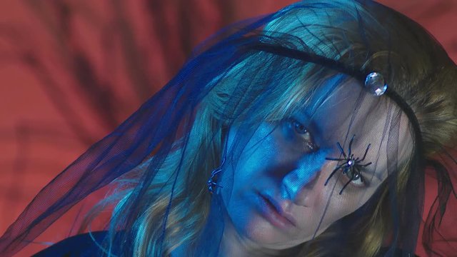 4k, slow motion, Halloween. Woman in costume of a terrible witch, swears looking at the camera, close-up