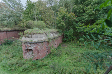 Fototapeta premium old German fortifications from red brick among the green forest