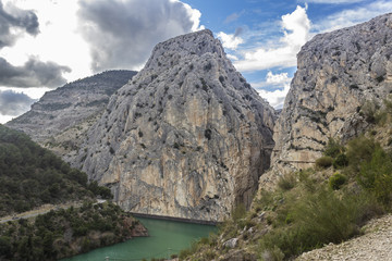 An amazing mountain scenery view of "El Chorro" or "Desfiladero de los Gaitanes" gorge and amazing cut on Earth showing us an awe rugged landscape with the river at the bottom of the mountain cliffs