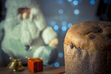 Panettone. Traditional italian dessert for christmas with chistimas light on background.