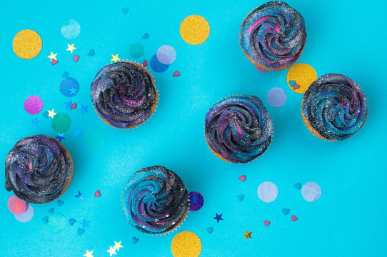 Vanilla cupcakes on party background