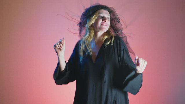 4k, slow motion, Halloween. Woman in costume of a terrible witch, swears looking at the camera
