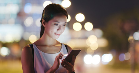 Woman use of mobile phone for order taxi at night
