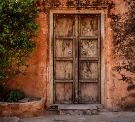 Old wooden door red wall at Jaigarh Fort, Jaipur - Powered by Adobe