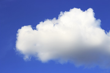 white large fluffy cloud in blue sky closeup texture background