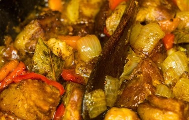 Roast meat, onions, carrots and spices, boiling in oil