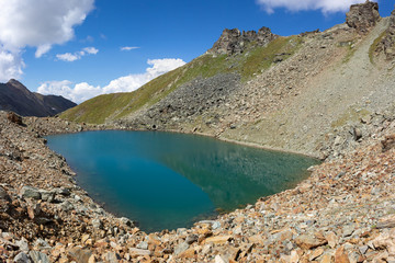 Hiking trail in Aosta valley, Cogne, Italy. Alpine lake of Garin. Photo taken at an altitude of 2900 meters.