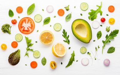 Food pattern with raw ingredients of salad on white wooden background.